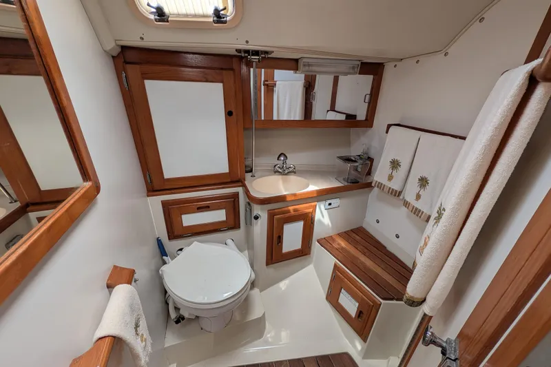 Slide: The Image of Interior of a 1995 Catalina 36 MkII sailboat, featuring wooden cabinetry and cozy sleeping quarters. - 22