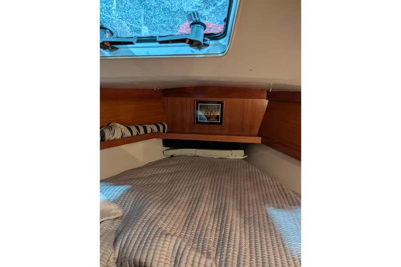 Slide: The Image of Cozy cabin interior of 1995 Catalina 36 MkII sailboat with bedding and window. - 6