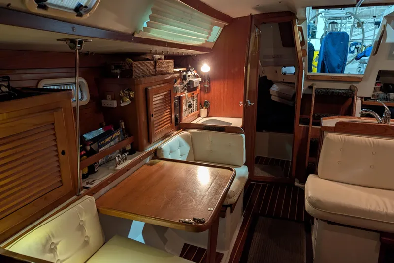 Slide: The Image of Interior of a 1995 Catalina 36 MkII sailboat with cozy seating and wooden cabinetry. - 9