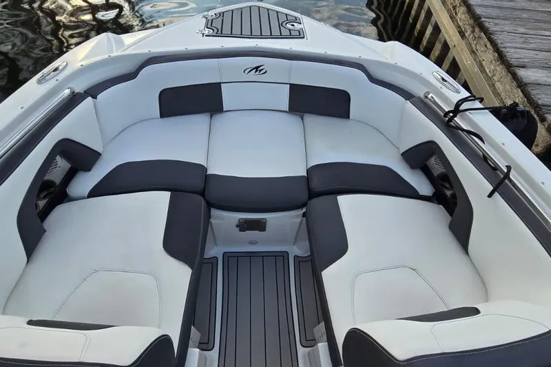 Slide: The Image of 2020 Monterey M-45 boat interior with white and black seating, dockside view. - 16