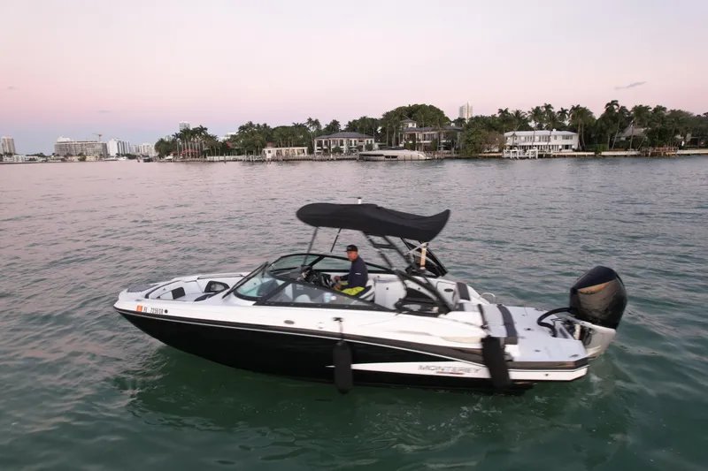 Slide: The Image of 2020 Monterey M-45 boat cruising on calm waters at sunset. - 2