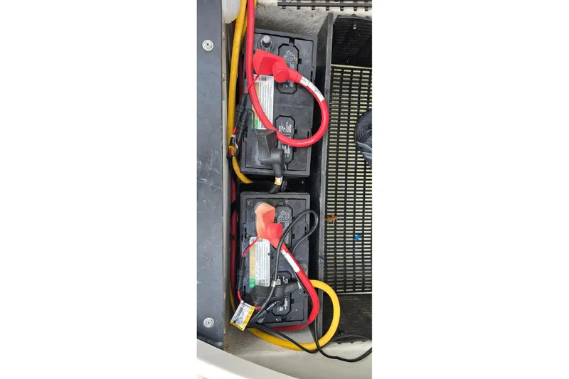 Slide: The Image of Two batteries with red and yellow cables in a 2020 Monterey M-45 boat. - 22