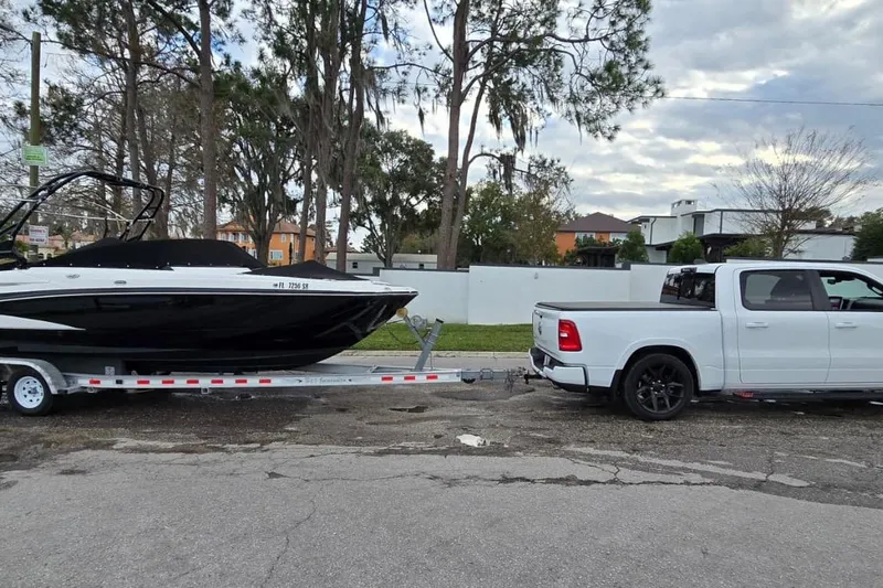 Slide: The Image of White truck towing a 2020 Monterey M-45 boat on a trailer, parked on a suburban street. - 25