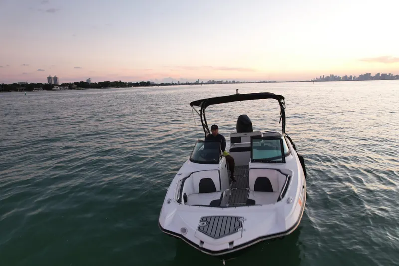 Slide: The Image of 2020 Monterey M-45 boat on calm water at sunset, city skyline in background. - 3