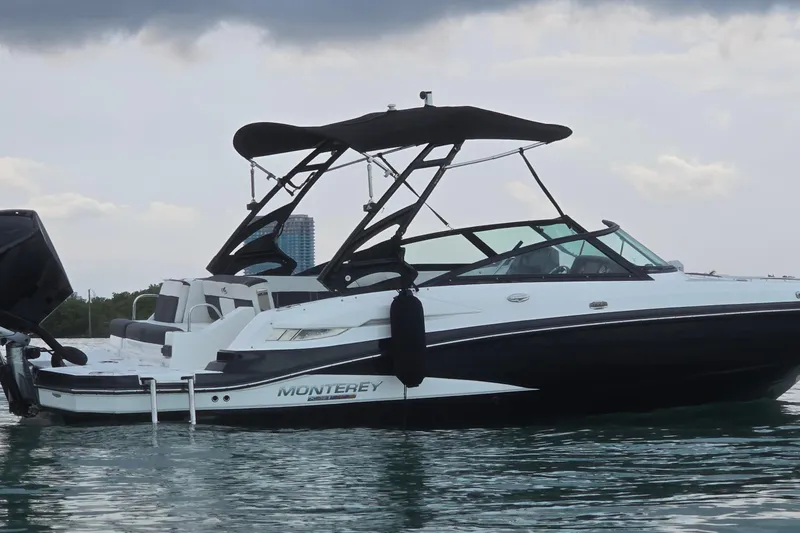 Slide: The Image of 2020 Monterey M-45 boat on water, featuring sleek design and modern canopy. - 33