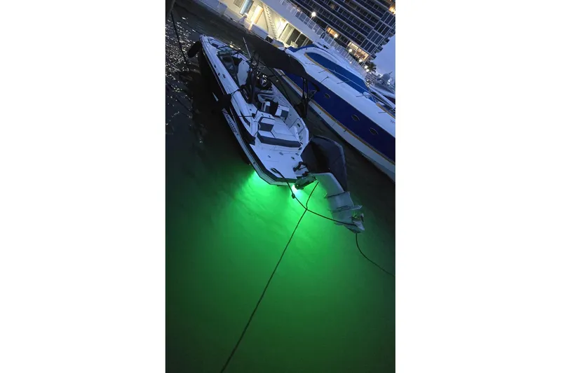 Slide: The Image of 2020 Monterey M-45 boat docked with glowing green underwater lights. - 39