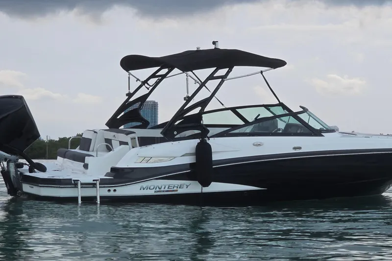 Slide: The Image of 2020 Monterey M-45 boat on water, featuring sleek design and black canopy. - 41