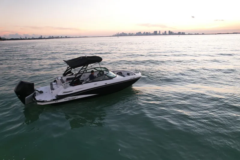 Slide: The Image of 2020 Monterey M-45 boat cruising on calm waters at sunset with city skyline. - 6