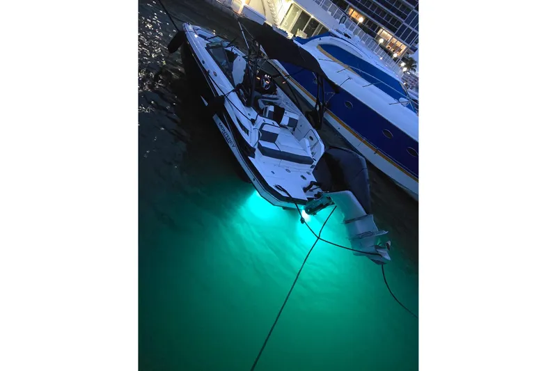 Slide: The Image of 2020 Monterey M-45 boat with glowing underwater lights docked at night. - 7