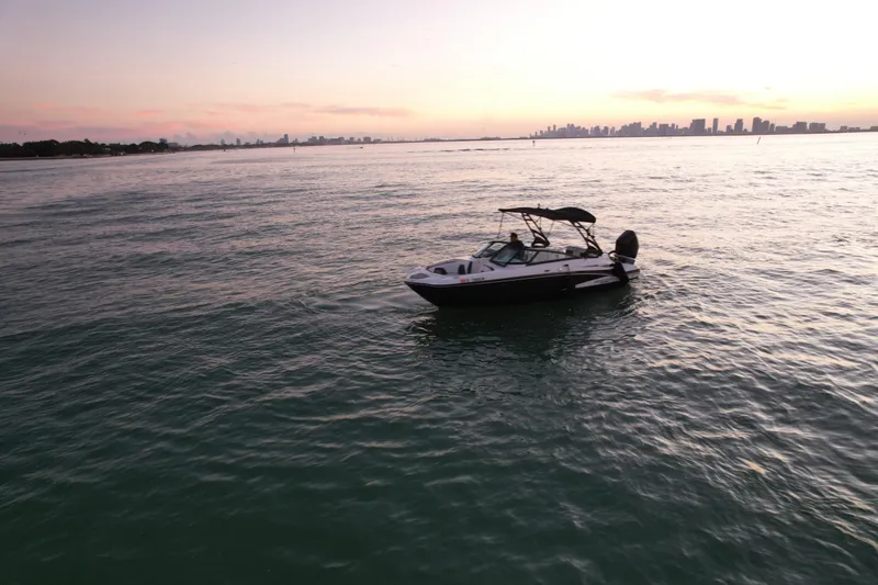 Slide: The Image of Boat on calm water at sunset, Monterey M-45, 2020 model, city skyline in background. - 8