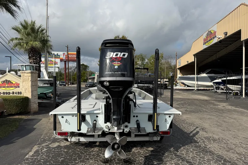 Slide: The Image of 2018 SCB Stingray boat with 300 XS engine at a marine dealership. - 12