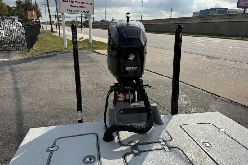 Slide: The Image of 2018 SCB Stingray boat with a 300 horsepower outboard motor, parked near a road. - 14