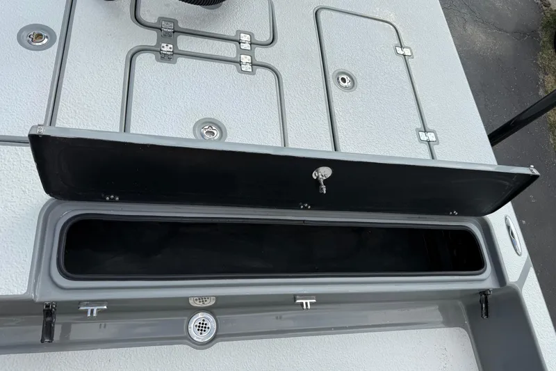 Slide: The Image of 2018 SCB Stingray boat storage compartment with open hatch and secure lock. - 19