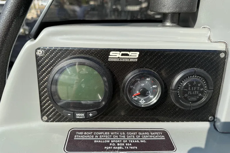 Slide: The Image of Dashboard of a 2018 SCB Stingray boat with gauges and safety compliance label. - 25