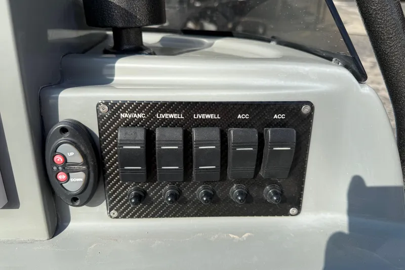 Slide: The Image of Control panel of a 2018 SCB Stingray boat with switches and buttons. - 28