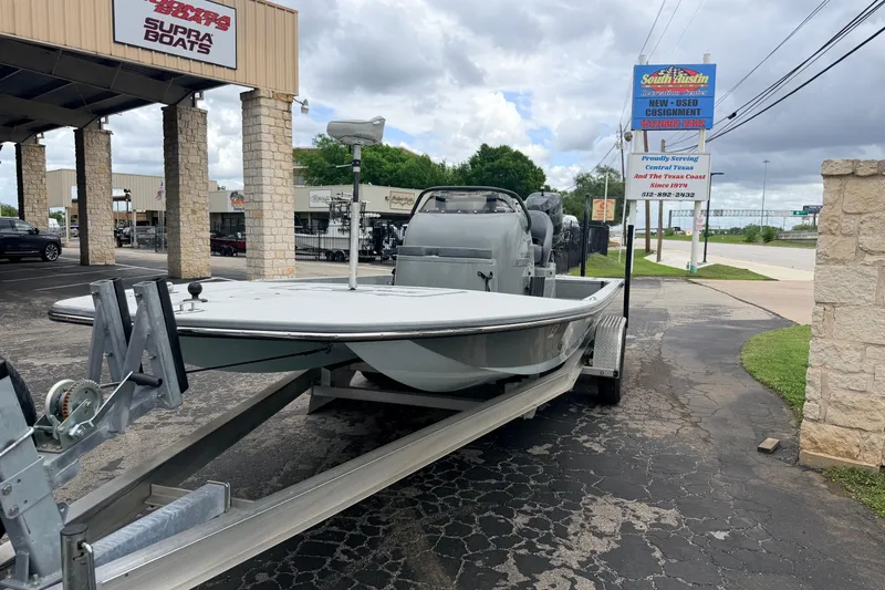 Slide: The Image of 2018 SCB Stingray boat on trailer at dealership, cloudy sky background. - 3