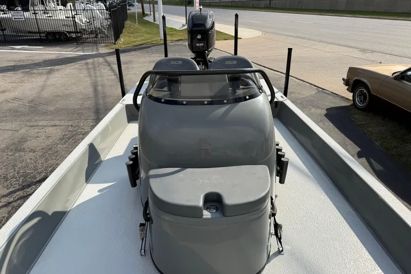 Slide: The Image of 2018 SCB Stingray boat with outboard motor, parked on pavement near a road. - 31
