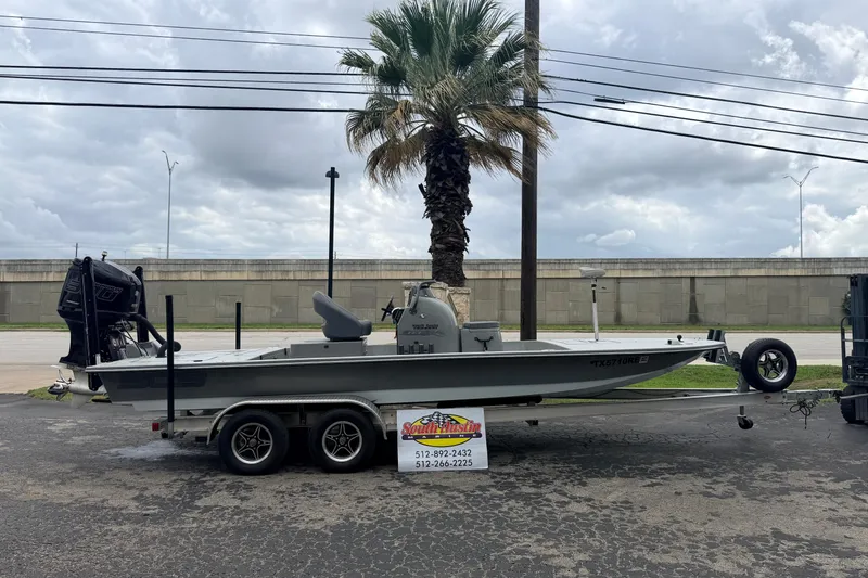 Slide: The Image of 2018 SCB Stingray boat on trailer, parked near palm tree under cloudy sky. - 35