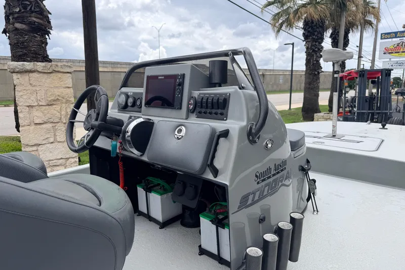 Slide: The Image of 2018 SCB Stingray boat dashboard with steering wheel and navigation system. - 8