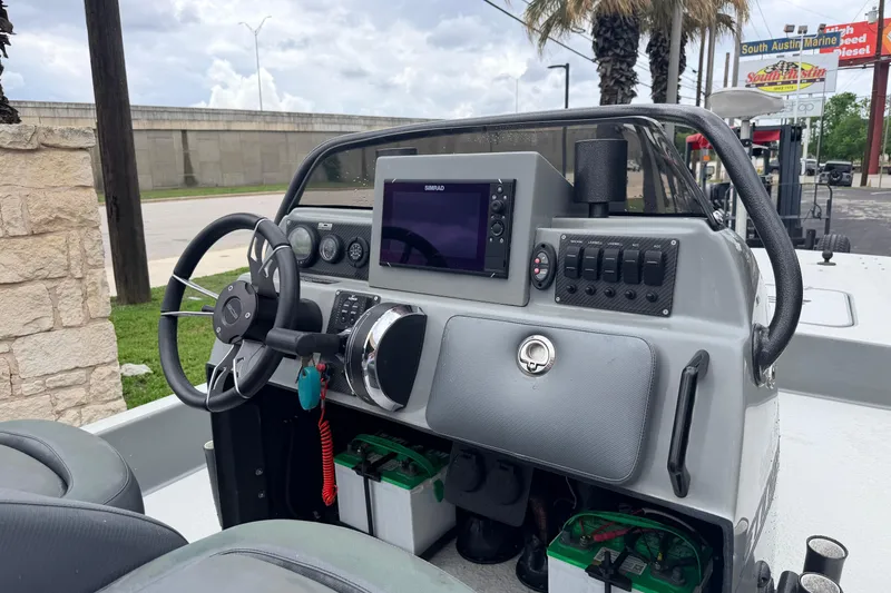 Slide: The Image of 2018 SCB Stingray boat dashboard with steering wheel, navigation system, and control panel. - 9