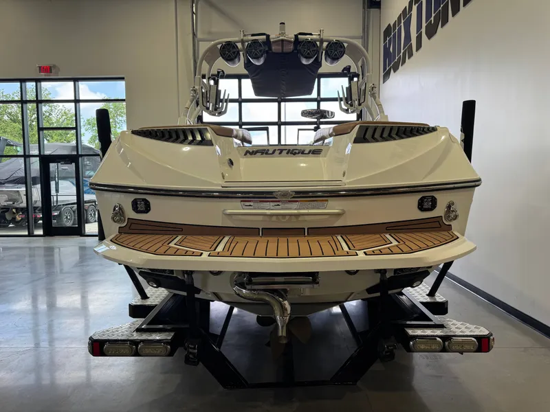 Slide: The Image of Rear view of a 2016 Nautique Super Air Nautique G23 boat in showroom. - 6