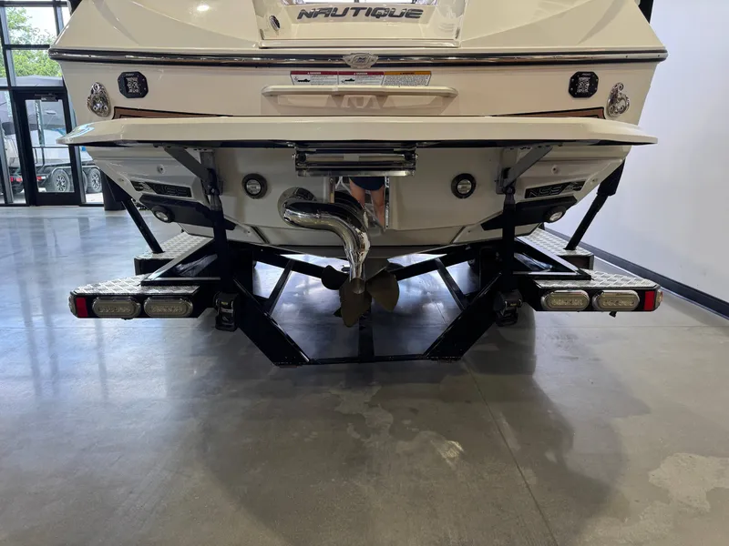 Slide: The Image of Rear view of a 2016 Nautique Super Air Nautique G23 boat on a trailer. - 7