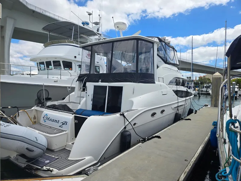 Slide: The Image of 2004 Meridian 459 Motoryacht docked under bridge. - 2