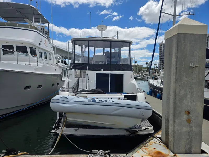 Slide: The Image of 2004 Meridian 459 Motoryacht docked with inflatable dinghy. - 3