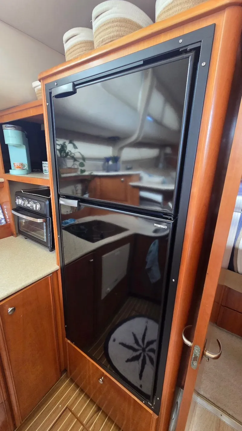 Slide: The Image of 2004 Meridian 459 Motoryacht kitchen with refrigerator. - 42