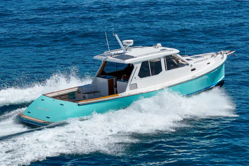 Slide: The Image of 2007 True North 38 boat cruising on blue ocean near scenic coastline. - 10