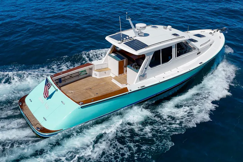 Slide: The Image of Stern view of 2007 True North 38 yacht with teak deck and ocean backdrop. - 14