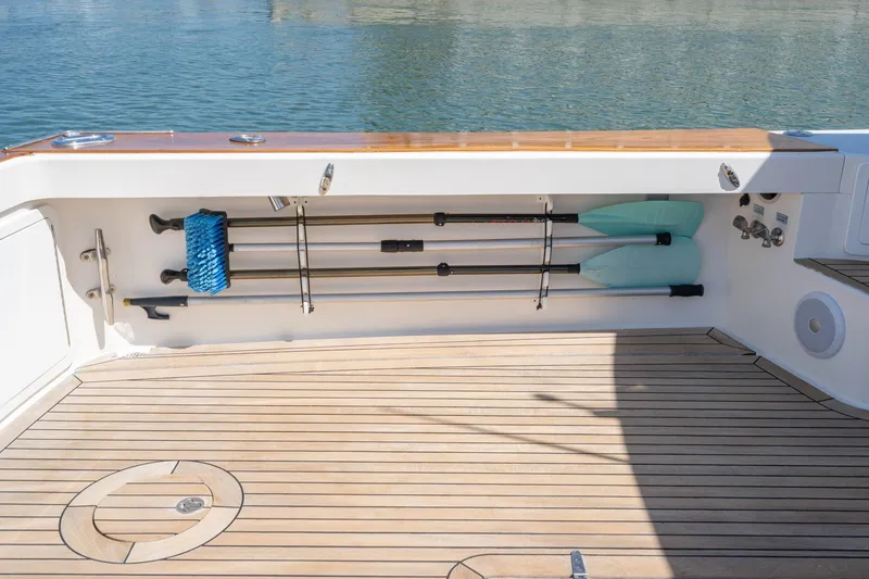 Slide: The Image of Deck of 2007 True North 38 boat with oars and cleaning brush stored neatly. - 16