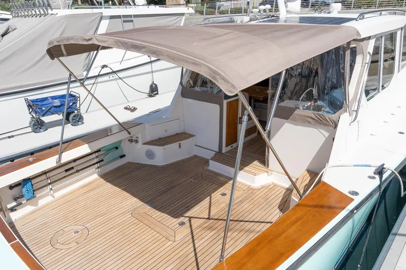 Slide: The Image of 2007 True North 38 boat with teak deck and canopy, docked at marina. - 19
