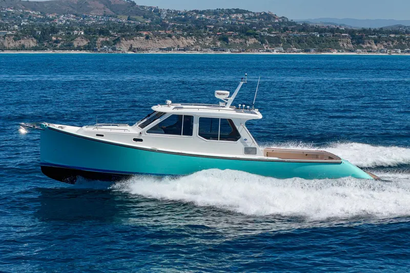 Slide: The Image of A 2007 True North 38 boat cruising on clear blue water. - 2