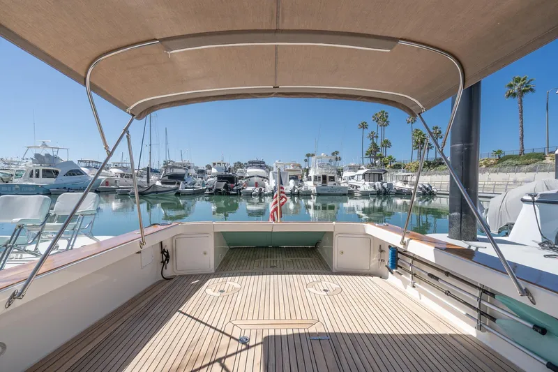 Slide: The Image of Spacious deck of 2007 True North 38 yacht in marina, featuring canopy and wooden flooring. - 20