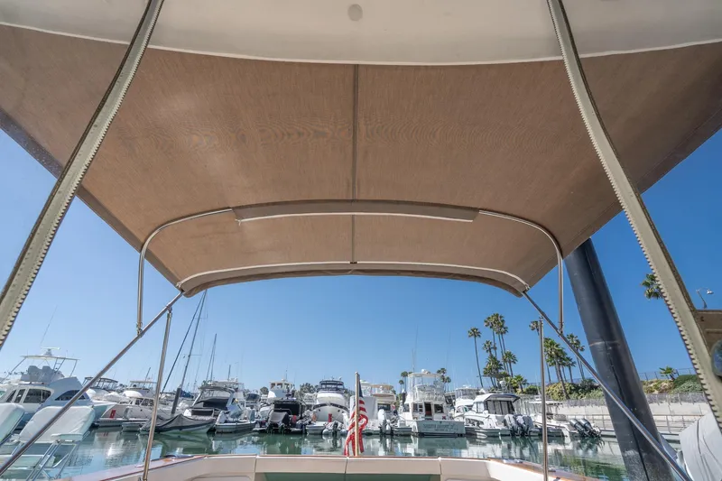 Slide: The Image of View from a 2007 True North 38 boat canopy overlooking a marina with docked yachts. - 21