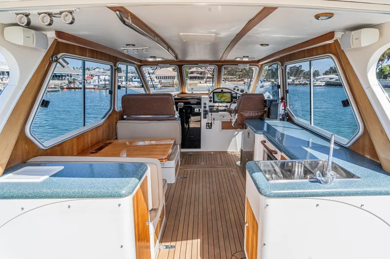 Slide: The Image of Interior of 2007 True North 38 boat with wood accents and waterfront view. - 24