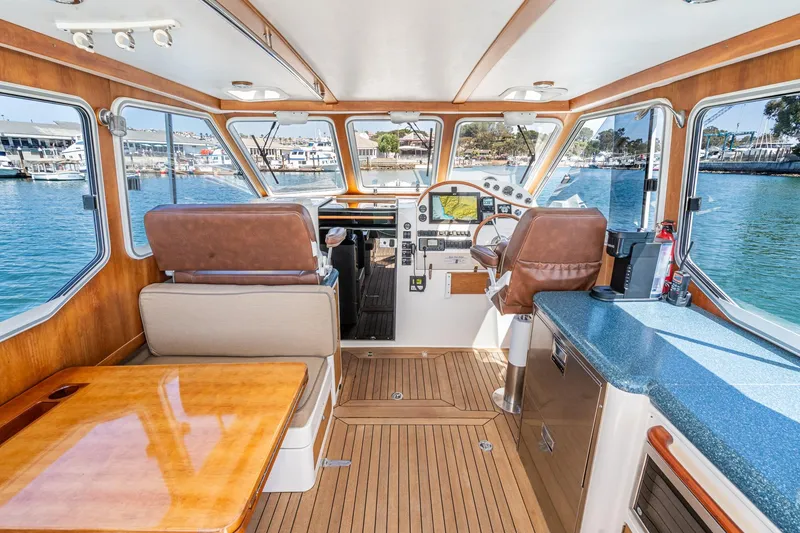 Slide: The Image of Interior of 2007 True North 38 boat with wood accents and marina view. - 25