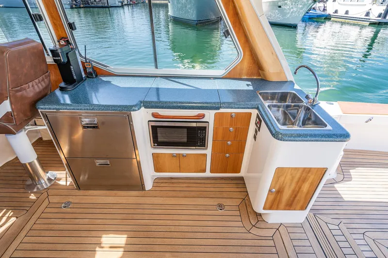Slide: The Image of Luxurious 2007 True North 38 yacht kitchen with modern appliances and elegant wood finish. - 27