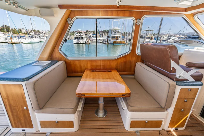 Slide: The Image of Interior of 2007 True North 38 yacht with wooden dining area and marina view. - 32