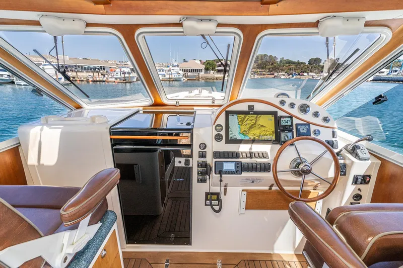 Slide: The Image of Pilothouse of 2007 True North 38 yacht with navigation equipment and scenic marina view. - 34