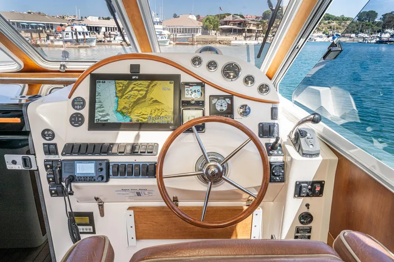 Slide: The Image of Helm of 2007 True North 38 boat with navigation equipment and waterfront view. - 35