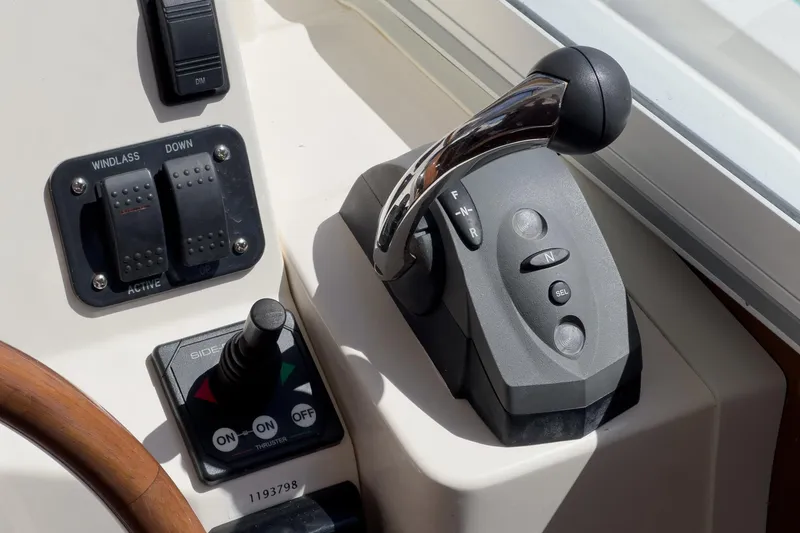 Slide: The Image of Control panel of a 2007 True North 38 boat with throttle and switches. - 39