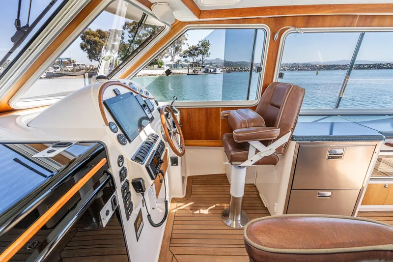 Slide: The Image of Interior of 2007 True North 38 boat with helm, leather seat, and scenic water view. - 40