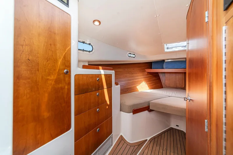 Slide: The Image of Cozy cabin interior of 2007 True North 38 yacht with wooden cabinetry and cushioned seating. - 44