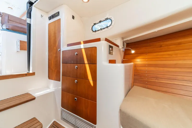 Slide: The Image of Interior of 2007 True North 38 boat with wooden cabinetry and cozy seating area. - 47