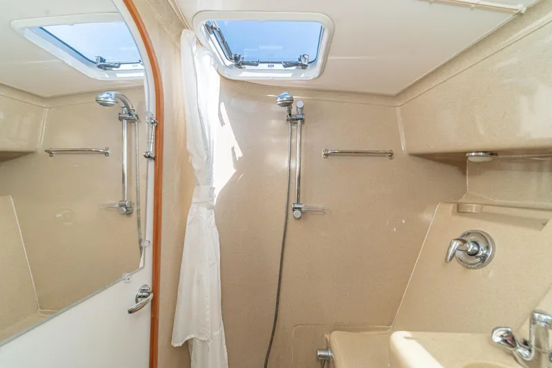 Slide: The Image of Bathroom interior of 2007 True North 38 yacht, featuring shower and porthole window. - 49