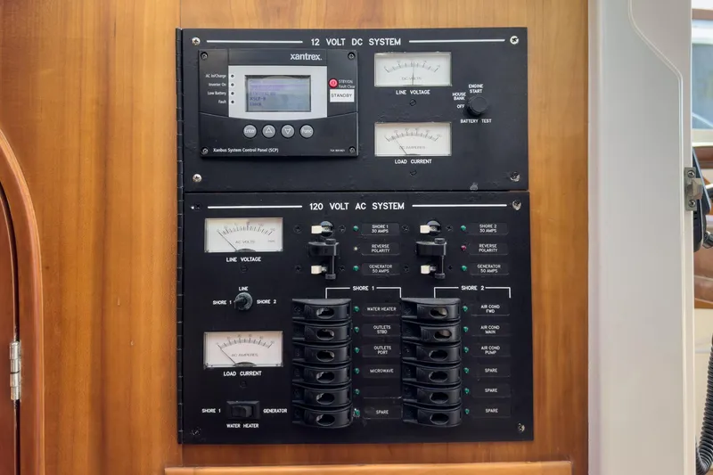 Slide: The Image of Electrical control panel on a 2007 True North 38 boat, featuring 12V DC and 120V AC systems. - 51