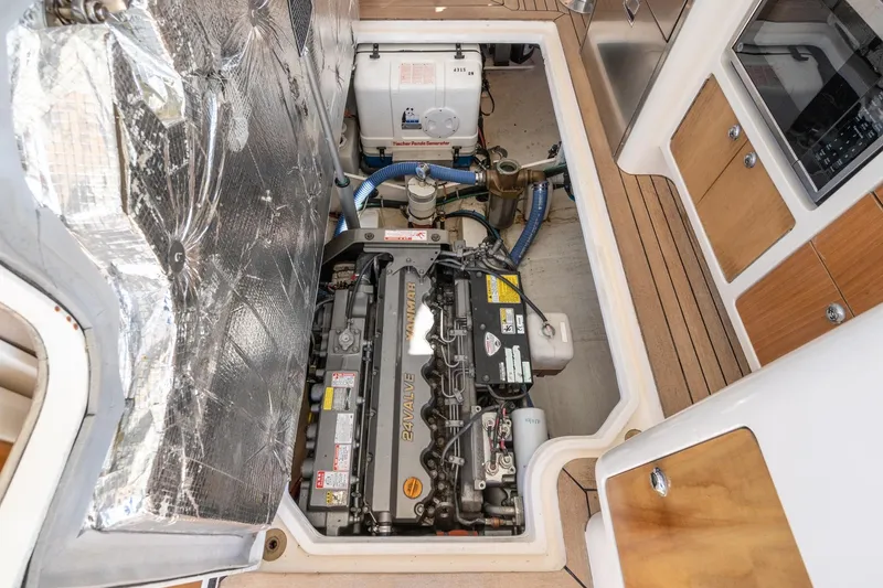 Slide: The Image of Engine compartment of a 2007 True North 38 boat, showcasing mechanical components and insulation. - 53
