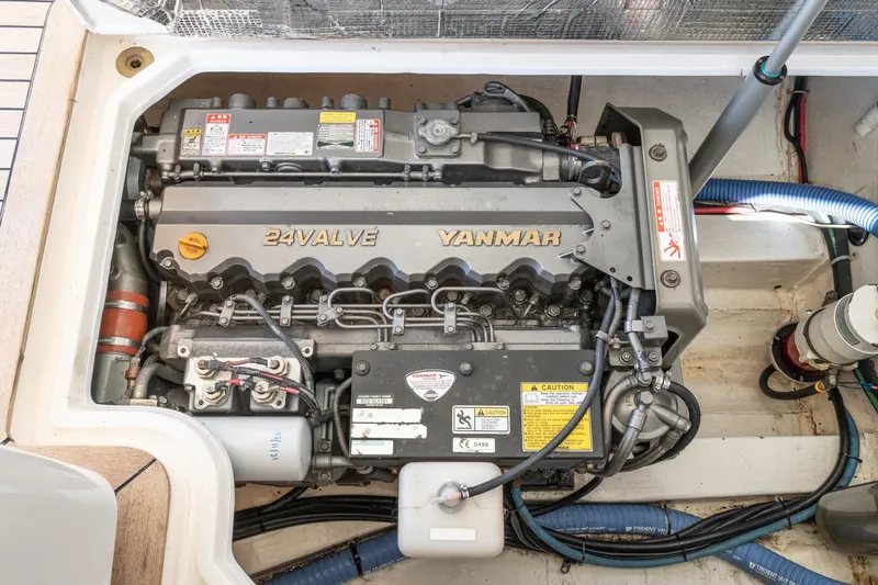 Slide: The Image of Engine compartment of a 2007 True North 38 boat featuring a Yanmar 24-valve engine. - 54